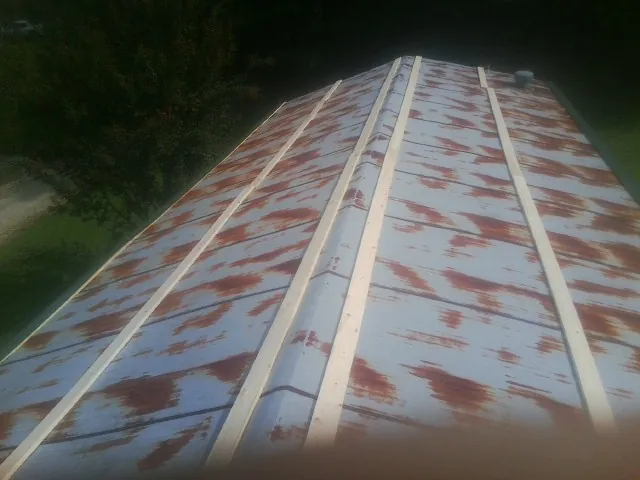 Rusted metal roof panels with new wood purlins before replacement — Storm Damage Roof Repair in Mineral City by Roofing Brothers